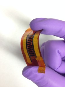 Rice University scientists made this supercapacitor with interlocked “fingers” using a laser and writing the pattern into a boron-infused sheet of polyimide. The device may be suitable for flexible, wearable electronics.  Credit: Tour Group/Rice University