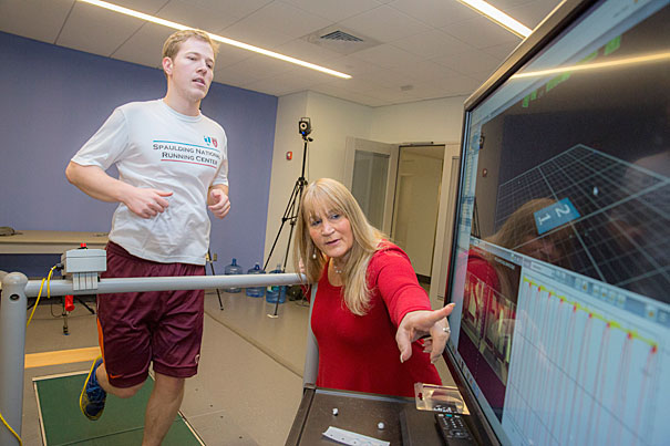 Irene Davis, a professor of Physical Medicine and Rehabilitation at HMS and head of the National Running Center at Spaulding Rehab in Cambridge (pictured), made a study that shows runners who run "lightly" have fewer injuries. On the treadmill is Laboratory Engineer at Spaulding National Running Center, Matthew Ruder. Kris Snibbe/Harvard Staff Photographer